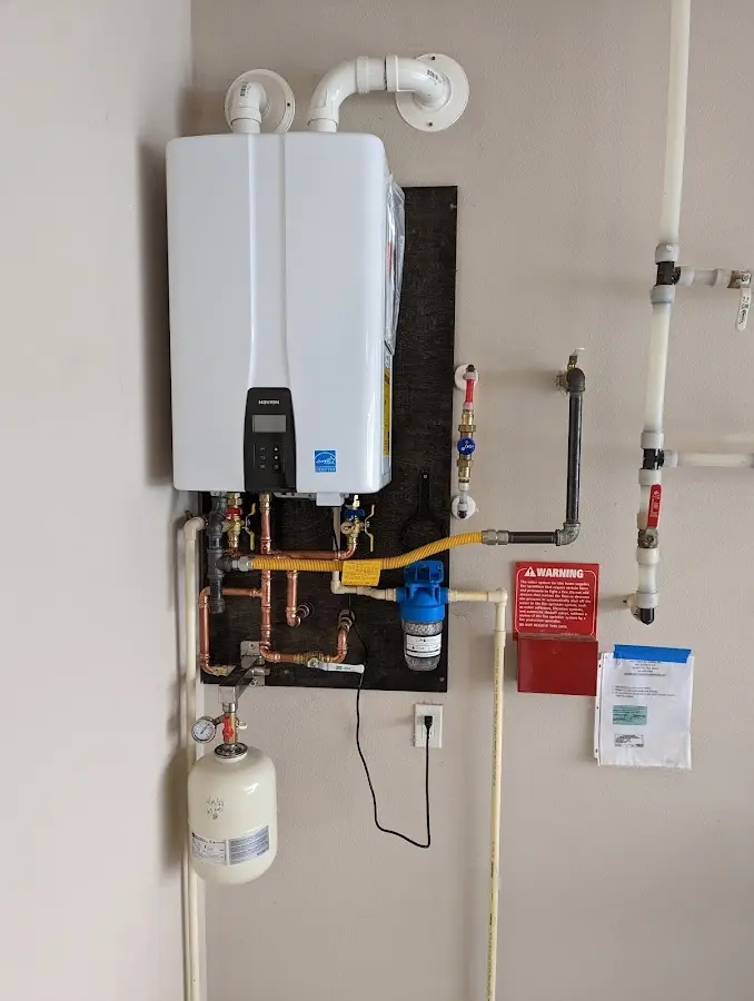 Professional plumber installing copper piping in a Richfield home